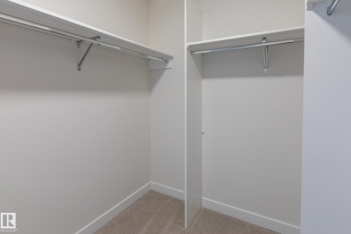 Wall-to-wall carpeting, white shelving, and hanging rods - 6306 65 Ave, Beaumont, AB 