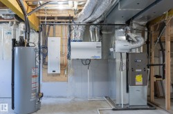 Water heater, HVAC system, exposed ductwork, exposed framing, and electrical panel - 