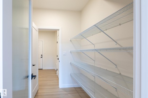 Walk-in pantry with multiple levels of wire shelving - 6306 65 Ave, Beaumont, AB 
