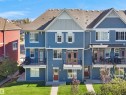 Three-story townhome with blue siding and white trim - #162 603 Watt Bv Sw, Edmonton, AB 