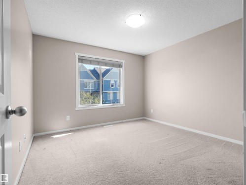 Neutral-toned walls complement the light-colored carpet flooring - #162 603 Watt Bv Sw, Edmonton, AB 