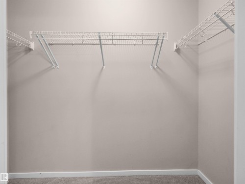 Closet featuring wall-mounted wire shelving and neutral wall paint - #162 603 Watt Bv Sw, Edmonton, AB 
