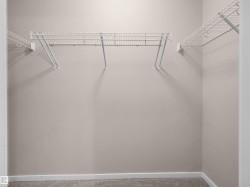 Closet featuring wall-mounted wire shelving and neutral wall paint - 