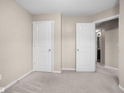 Light-colored carpeting, neutral wall paint, white trim, and paneled interior doors - 