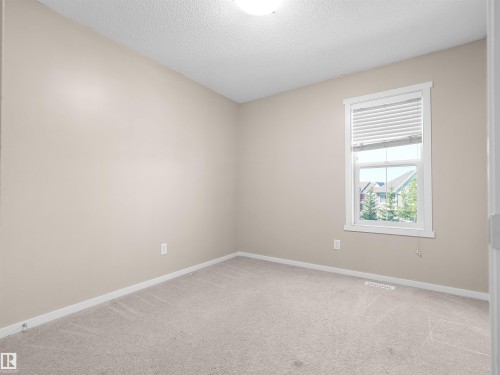 Light-toned walls, neutral carpet, and a white-trimmed window with blinds - #162 603 Watt Bv Sw, Edmonton, AB 