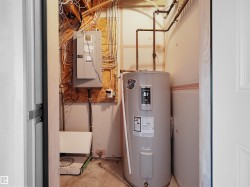 Water heater, electrical panels, and exposed utility lines - 