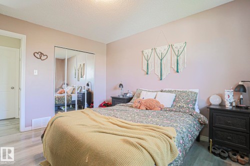 Wood-finish flooring, mirrored closet doors, and recessed lighting - 21 Burlington Avenue, Spruce Grove, AB 
