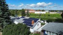 Solar panel system installed on a shingled roof, featuring a brick chimney - 21 Burlington Avenue, Spruce Grove, AB 