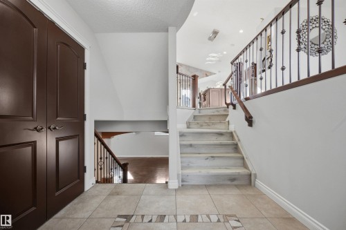 Entrance foyer with glass-insert front door and tiled floor - 10819 175 Avenue Nw, Edmonton, AB 