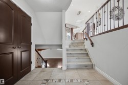 Entrance foyer with glass-insert front door and tiled floor - 
