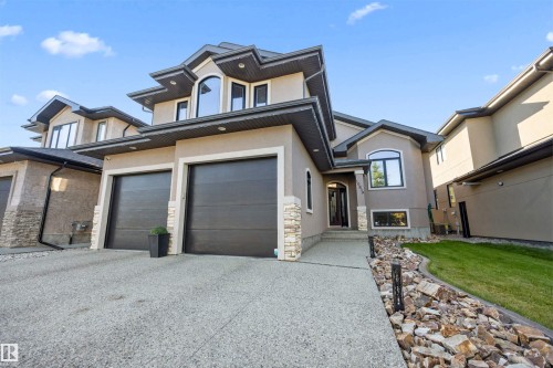 Exterior front of home with exposed aggregate concrete driveway - 10819 175 Avenue Nw, Edmonton, AB 
