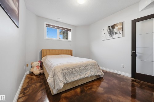 Large basement bedroom with French doors, in-floor heating and large closet - 10819 175 Avenue Nw, Edmonton, AB 