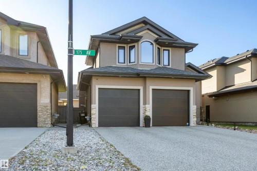 Exterior front of home with exposed aggregate concrete driveway - 10819 175 Avenue Nw, Edmonton, AB 