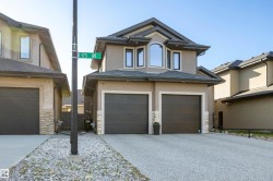 Exterior front of home with exposed aggregate concrete driveway - 