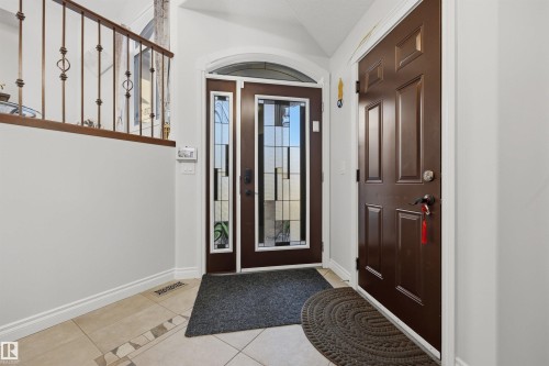 Entrance foyer with glass-insert front door and tiled floor - 10819 175 Avenue Nw, Edmonton, AB 