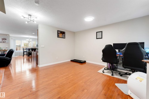 Hardwood-finish flooring, recessed lighting, and a contemporary ceiling light fixture - 3012 25 Ave Avenue Nw, Edmonton, AB 
