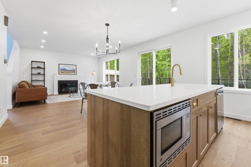 132 Heron Point Close, Rural Wetaskiwin County, AB - Indoor Photo Showing Kitchen With Fireplace