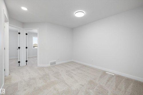 Plush carpet flooring, recessed lighting, ceiling-mounted light fixture, white walls, and white trim - 960 Elderberry Landing Nw, Edmonton, AB 