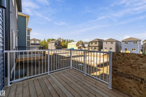 Wood-finish deck with white metal railings - 960 Elderberry Landing Nw, Edmonton, AB 