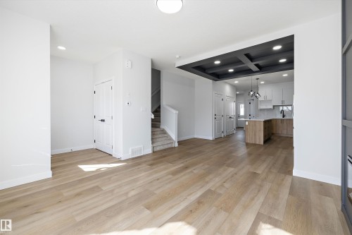 Open concept living space with light wood-finish flooring, recessed lighting, and white walls - 960 Elderberry Landing Nw, Edmonton, AB 