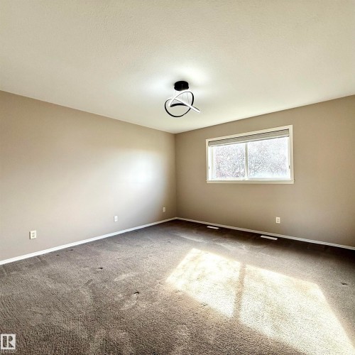 Window with horizontal blinds, neutral wall paint, and a contemporary ceiling light fixture - 910 Oakland Boulevard, Devon, AB 