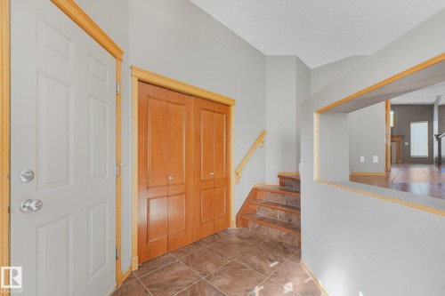 Entryway featuring a paneled door, wood-finish trim, and tile flooring - 1271 Ormsby Lane Nw, Edmonton, AB 