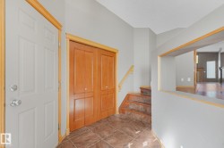 Entryway featuring a paneled door, wood-finish trim, and tile flooring - 