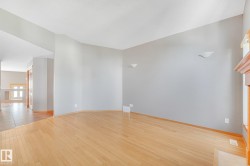 Light wood-finish flooring, neutral wall tones, and recessed ceiling lighting - 