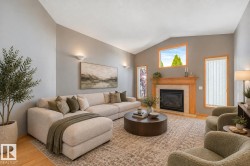 Vaulted ceiling with wall sconces, wood-finish flooring, fireplace with wood mantel and surround, and multiple windows with wood trim - 