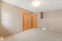 Neutral wall color with two wood doors and carpeted flooring - 