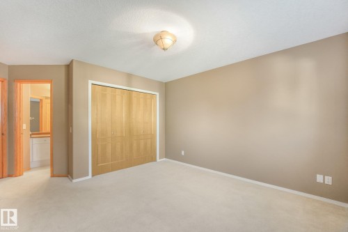 Neutral-toned walls complement the light-colored carpeting - 1271 Ormsby Lane Nw, Edmonton, AB 
