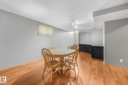 Wood-finish flooring, recessed lighting, built-in cabinetry, and window treatments - 1271 Ormsby Lane Nw, Edmonton, AB 