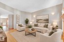 Vaulted ceilings, light-toned walls, sconce lighting, and wood-finish flooring - 1271 Ormsby Lane Nw, Edmonton, AB 