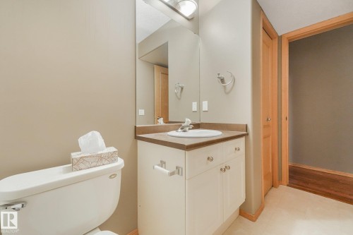 Built-in vanity with an integrated sink, polished chrome faucet, and storage cabinetry - 1271 Ormsby Lane Nw, Edmonton, AB 