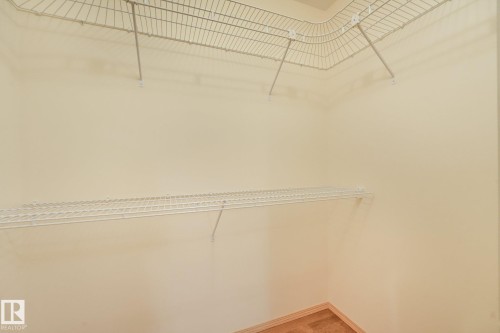 Closet storage featuring white wire shelving and wood-finish flooring - 1271 Ormsby Lane Nw, Edmonton, AB 