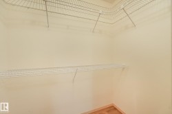 Closet storage featuring white wire shelving and wood-finish flooring - 