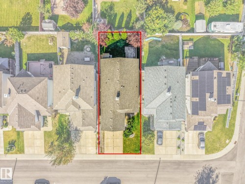 Sloped roof, paved driveway, mature landscaping, front yard, and backyard - 1271 Ormsby Lane Nw, Edmonton, AB 