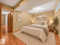Recessed ceiling with an overhead light fixture, wood-finish flooring, and a window with horizontal blinds - 
