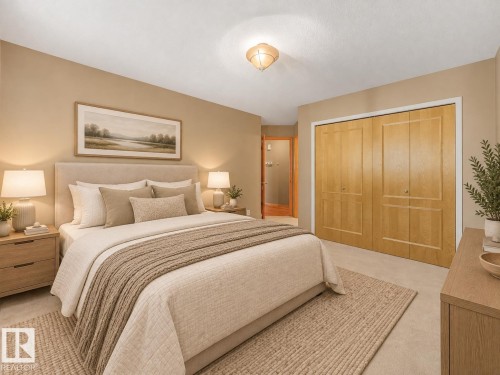 Neutral tone walls, ceiling-mounted light fixture, light wood bi-fold closet doors, wall-to-wall carpeting, and wood-finish trim - 1271 Ormsby Lane Nw, Edmonton, AB 