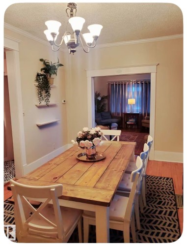 Recessed archway, crown molding, wood-finish flooring, built-in shelving, and a decorative chandelier - 10649 125 Street Nw, Edmonton, AB 