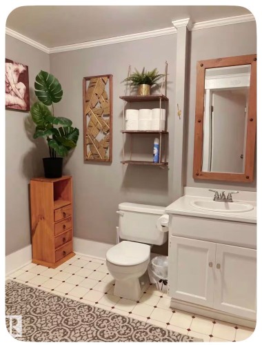 White vanity with an integrated basin and chrome faucet - 10649 125 Street Nw, Edmonton, AB 