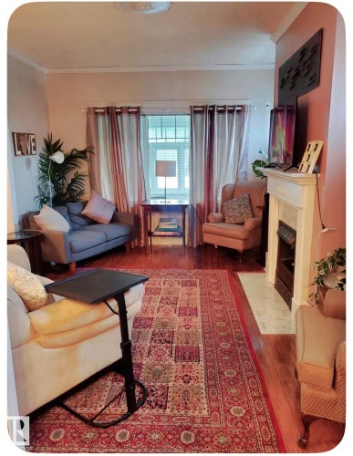 Hardwood flooring, crown molding, built-in fireplace, and a large window with transom detailing - 10649 125 Street Nw, Edmonton, AB 