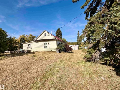 Gable roofline, light-colored siding, and white trim accents - 4910 50 Avenue, Spedden, AB 