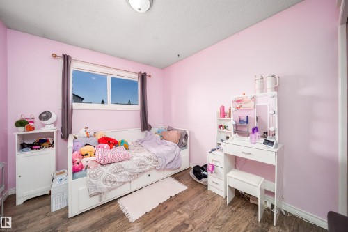 Wood-finish flooring with light pink wall paint - 4104 44 Street, Stony Plain, AB 