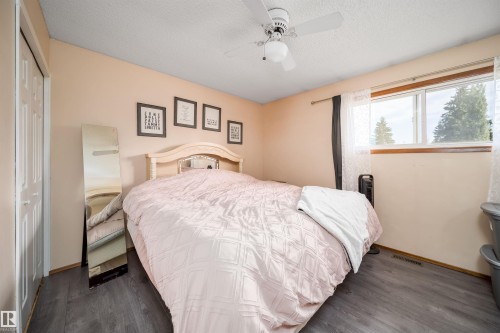 Wood-finish flooring, a ceiling fan with integrated lighting, and a double-pane window - 4104 44 Street, Stony Plain, AB 