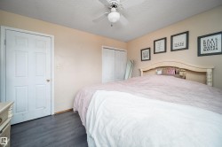 Wood-finish flooring with a neutral wall color and ceiling fan - 