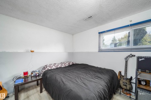 Wood-finish flooring with a horizontal window featuring horizontal blinds - 4104 44 Street, Stony Plain, AB 