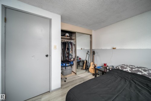 Wood-finish flooring with a mirrored closet door - 4104 44 Street, Stony Plain, AB 