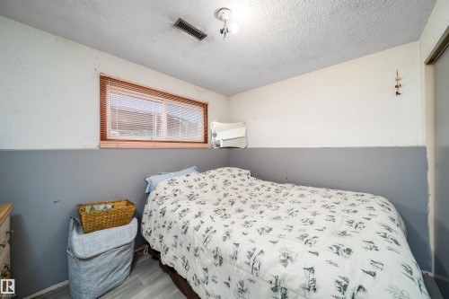 Wood-finish flooring with a horizontal window featuring blinds - 4104 44 Street, Stony Plain, AB 