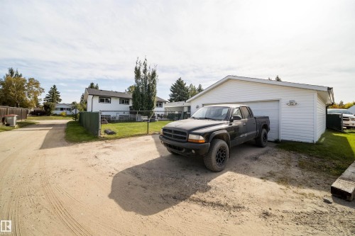 Detached garage with white siding and a gravel driveway - 4104 44 Street, Stony Plain, AB 
